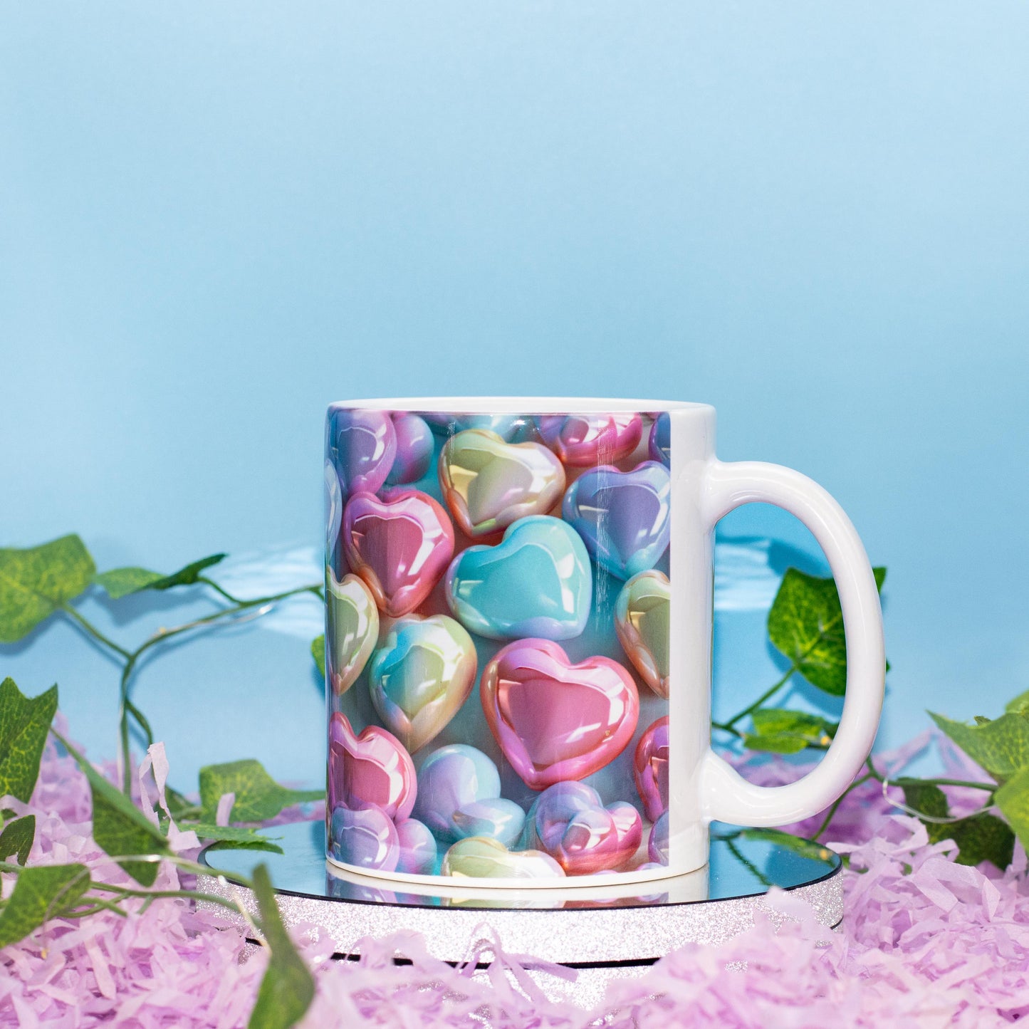 A ceramic mug with a colorful print of glossy, pastel heart-shaped candies