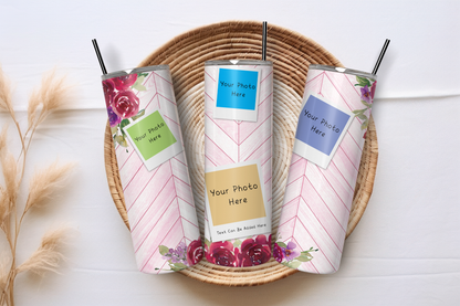Three customizable skinny tumbler cups with pink and white chevron patterns and floral accents, displayed in a round woven tray on a white wooden surface.