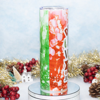 A tall insulated tumbler with a clear lid, featuring a split holiday design with green bokeh on the left and orange marbled splatter on the right. 