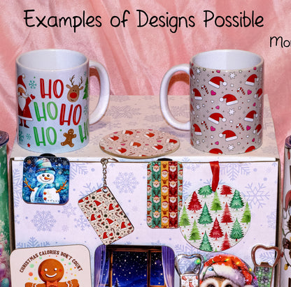 A collection of Christmas-themed mugs and matching accessories displayed on a box against a pink fabric backdrop. The mugs feature holiday prints including Santa, reindeer, candy canes, and snowflakes, with the text 'Examples of Designs Possible' at the top.