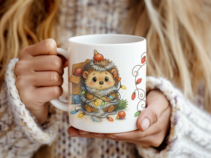A person holding a white ceramic mug with a cute hedgehog illustration wrapped in holiday lights. 