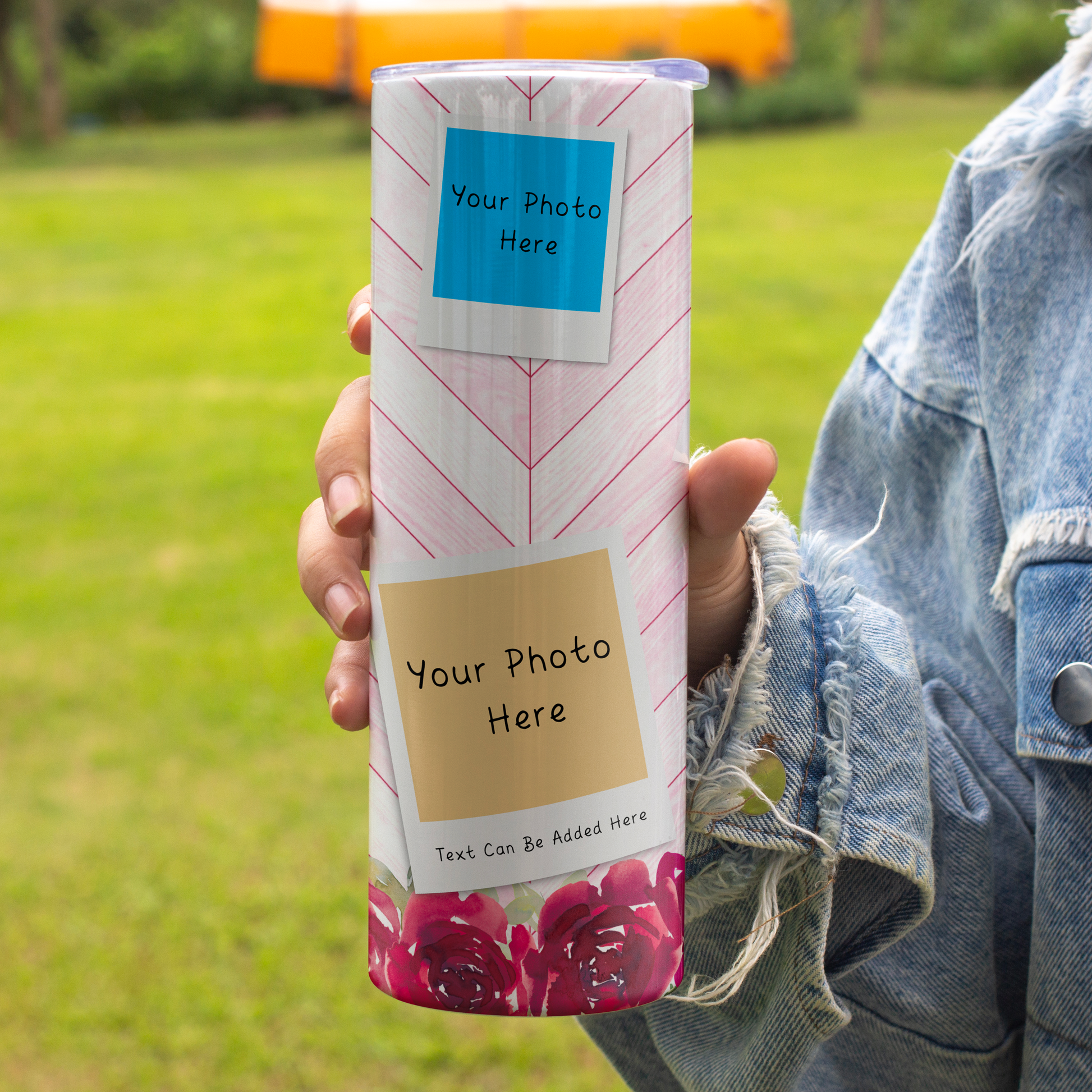 A person holds a custom photo tumbler outdoors on a grassy lawn. The holder features a white background with pink chevron lines, a blue sample photo label, a tan sample photo label, and a pink rose pattern at the bottom.