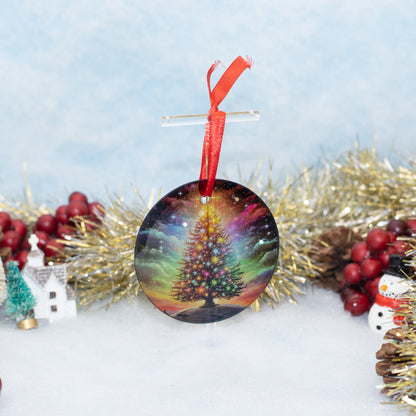 A round Christmas ornament featuring a colorful tree of life in a galaxy-like sky, hanging from a red ribbon on a clear stand, surrounded by festive tinsel, berries, and small holiday decorations.