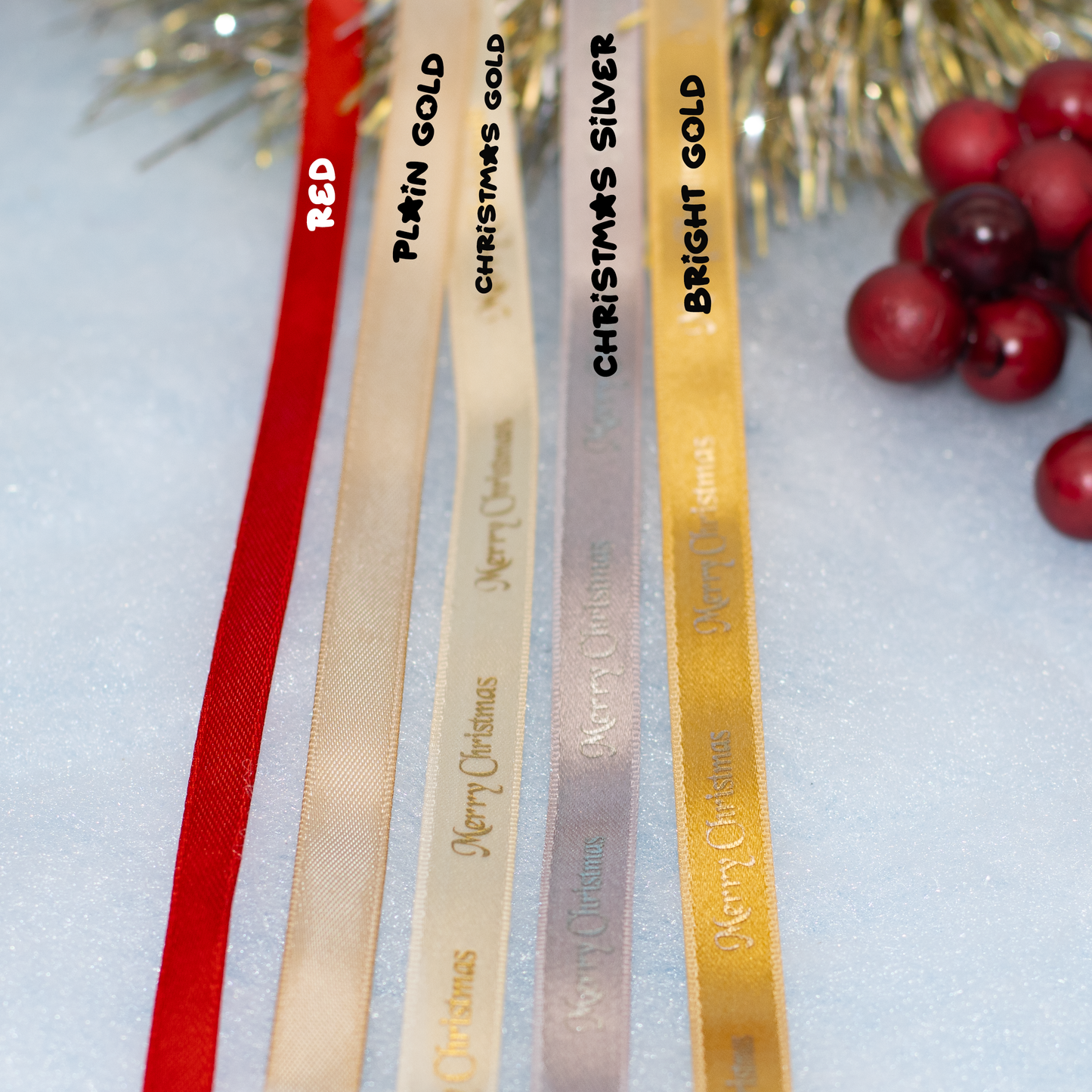 Five Christmas ribbon color options are shown in a close-up: red, plain gold, Christmas gold, Christmas silver, and bright gold, with festive tinsel and red berries as props on a light background.