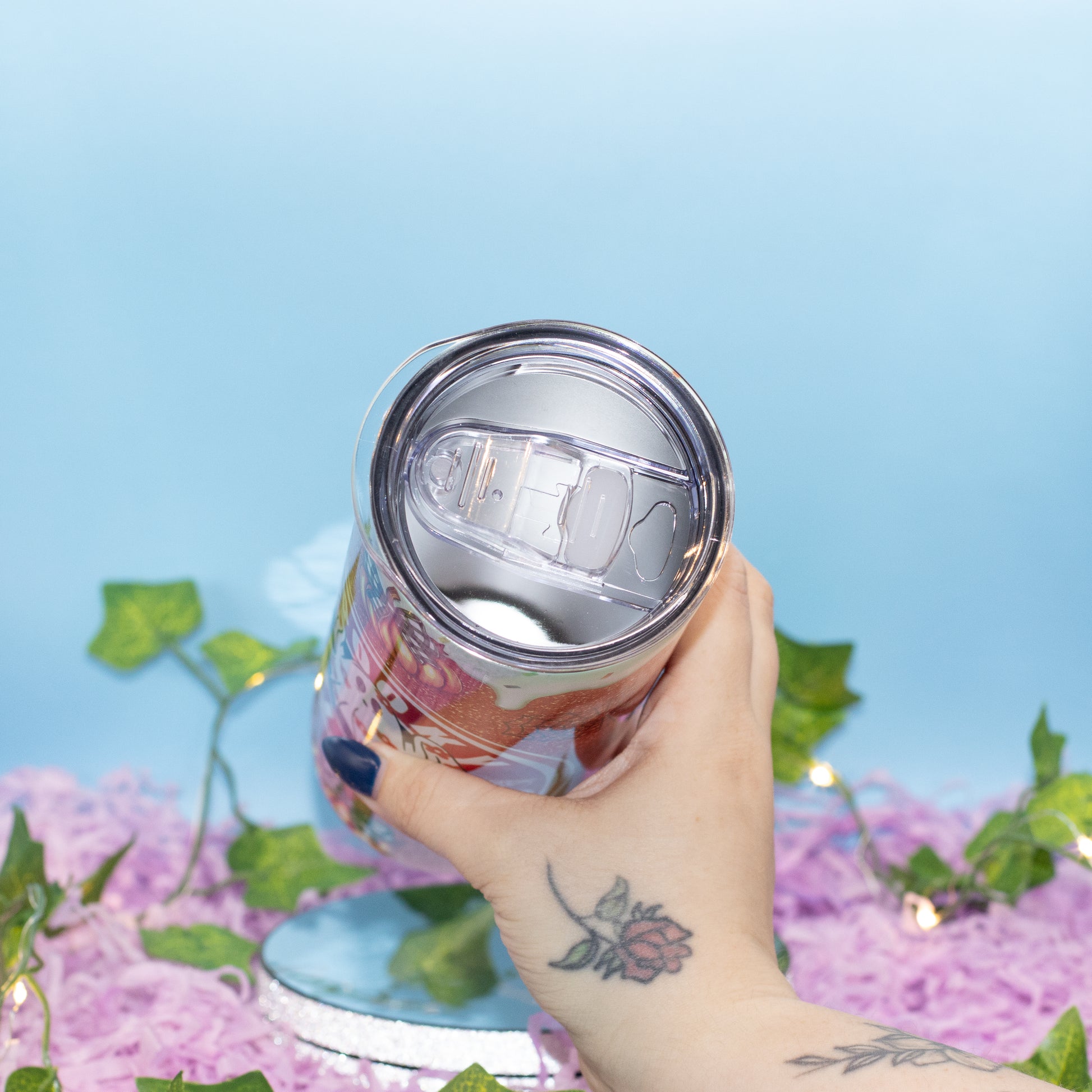 A hand holds a halloween tumbler to showcase the inside of the tumbler showing a stainless steel interior