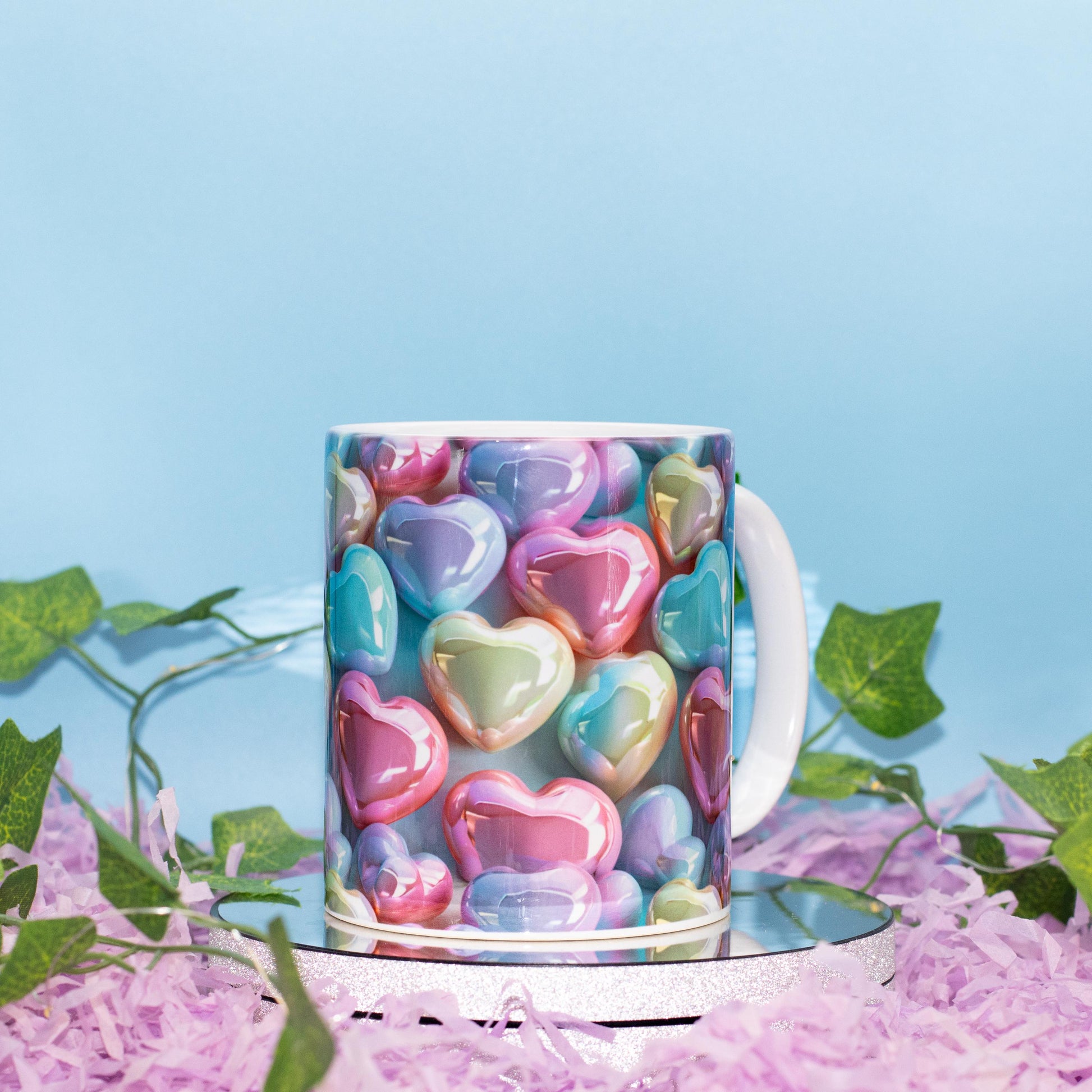 A ceramic mug with a colorful print of glossy, pastel heart-shaped candies