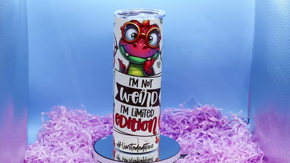 Video Showcasing A cylindrical tumbler with a colourful cartoon dino graphic and the text 'I'M Not weird I'M Limited Edition'