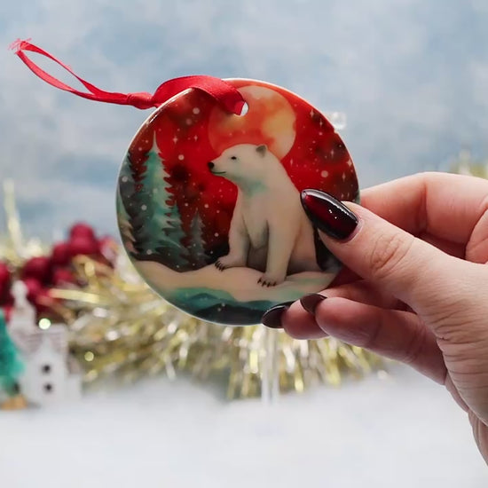 Video showcasing a double sided polar bear illustrated Christmas ornament