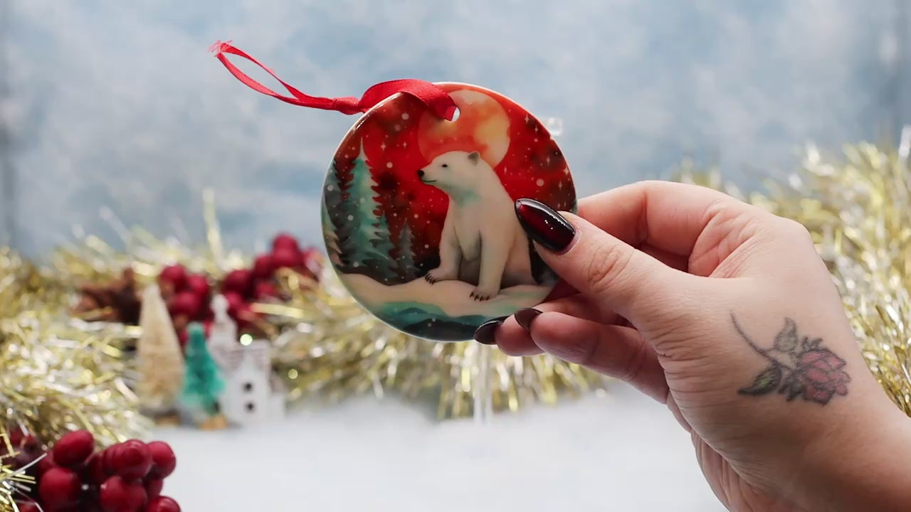 Video showcasing a double sided polar bear illustrated Christmas ornament