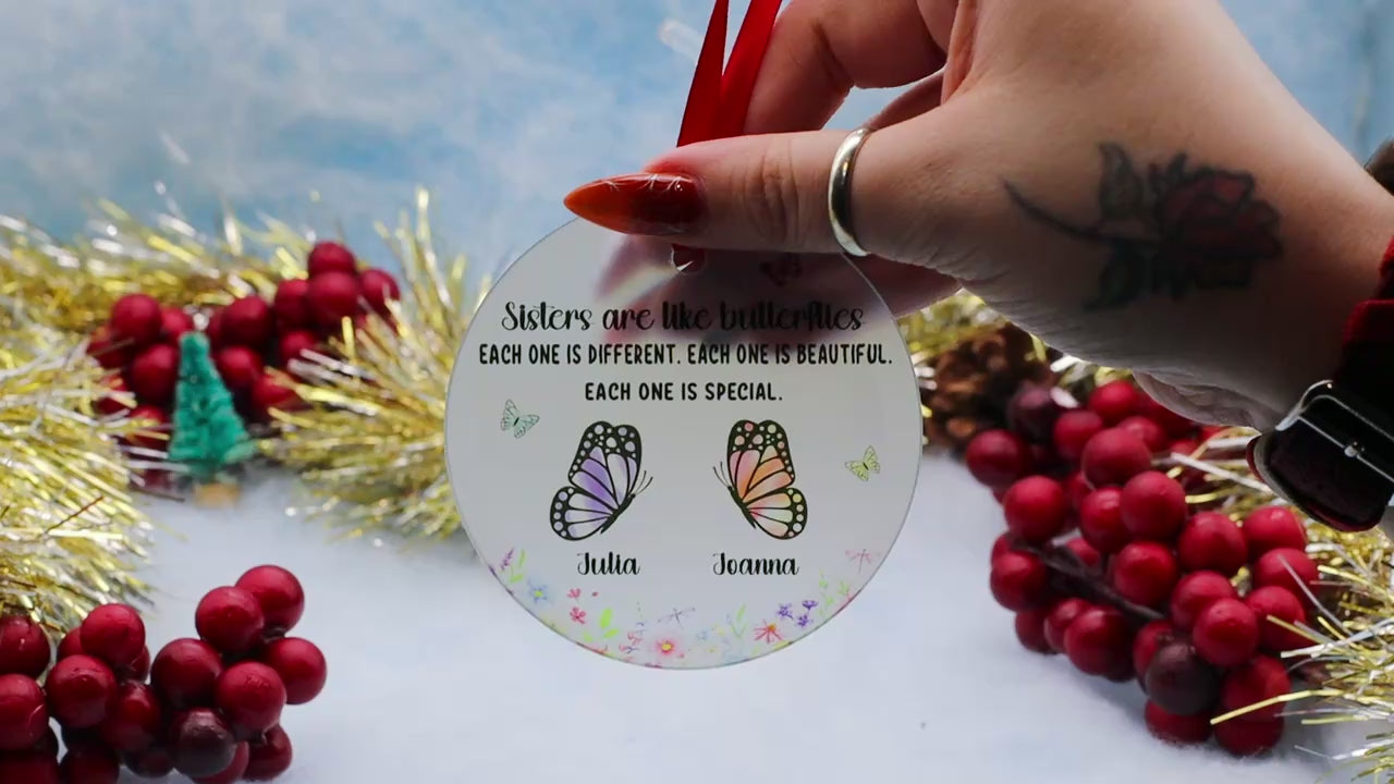Video Showcasing a frost glass ornament with this inscription of Sisters are like butterflied, Each one is different, each one is beautiful, each one is special