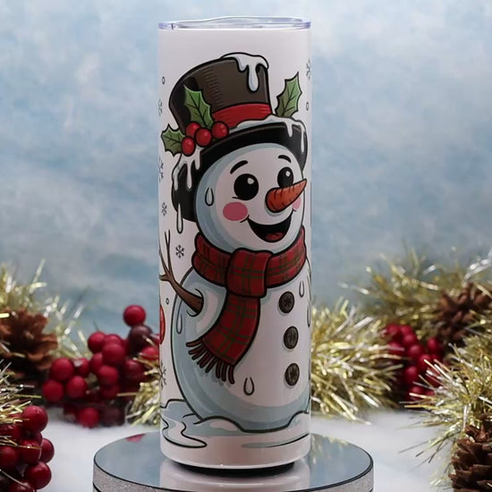 Video Showcasing A white insulated tumbler with a holiday snowman illustration and the text 'I'M HAVING MELTDOWN' displayed on a round pedestal,