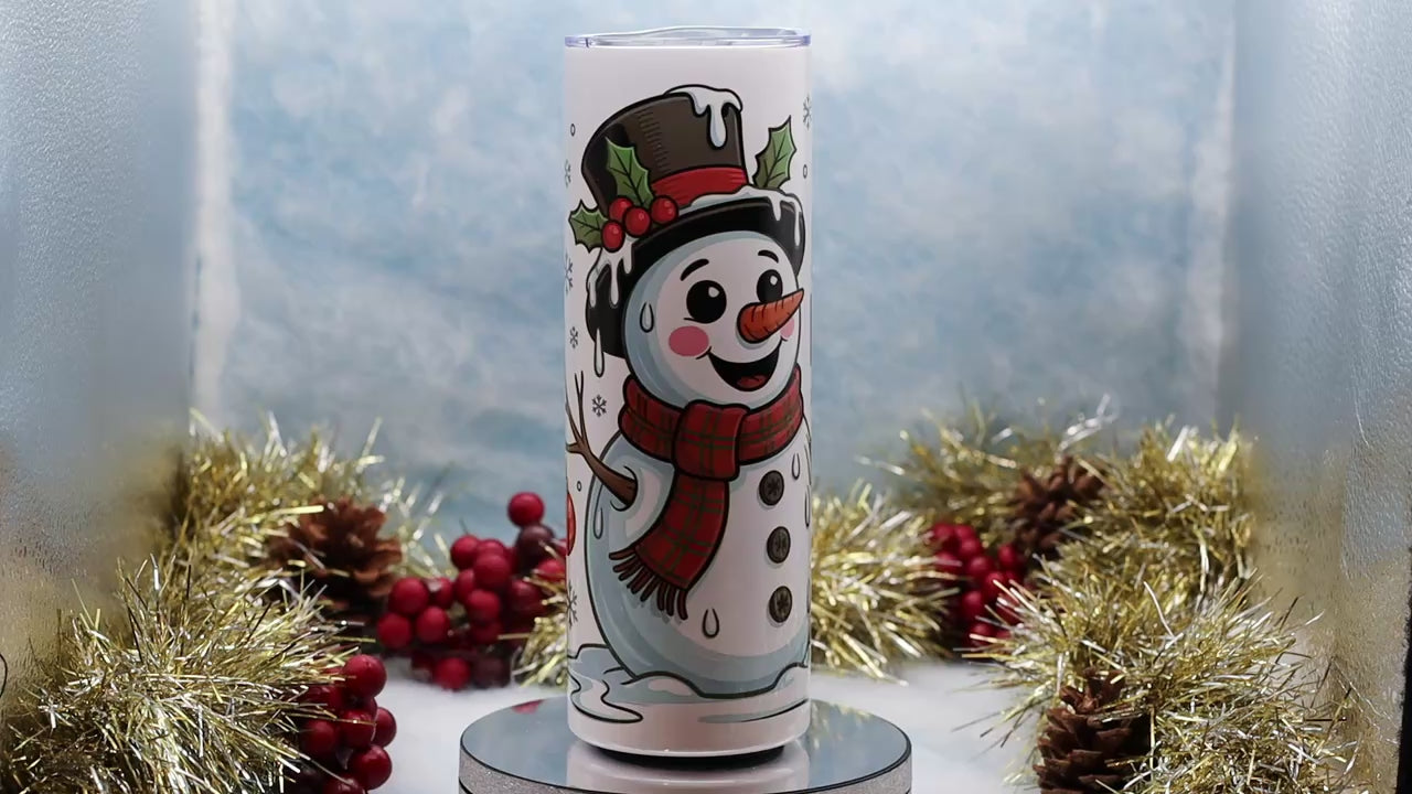 Video Showcasing A white insulated tumbler with a holiday snowman illustration and the text 'I'M HAVING MELTDOWN' displayed on a round pedestal,