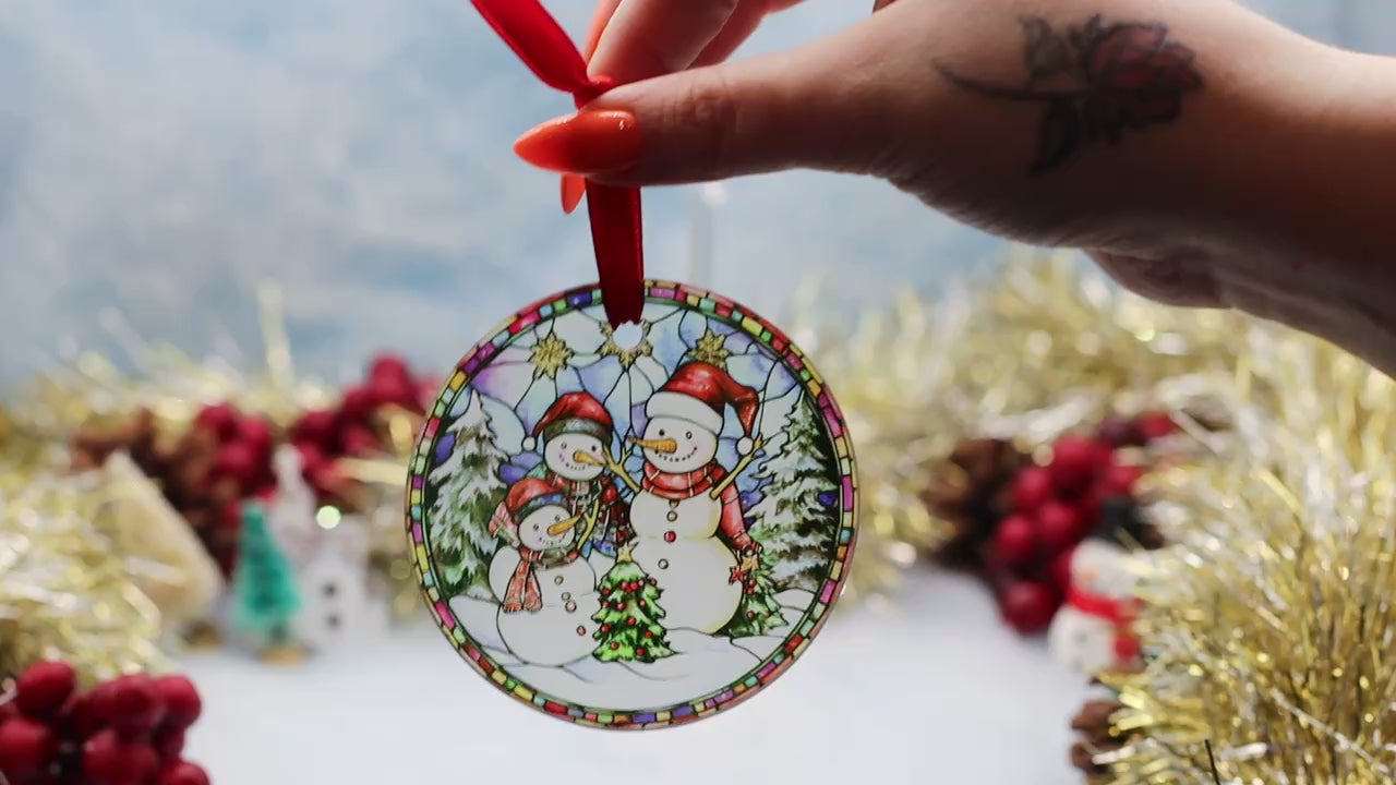 Video showcasing a frosted glass Christmas ornament featuring a winter scene with a snowman family