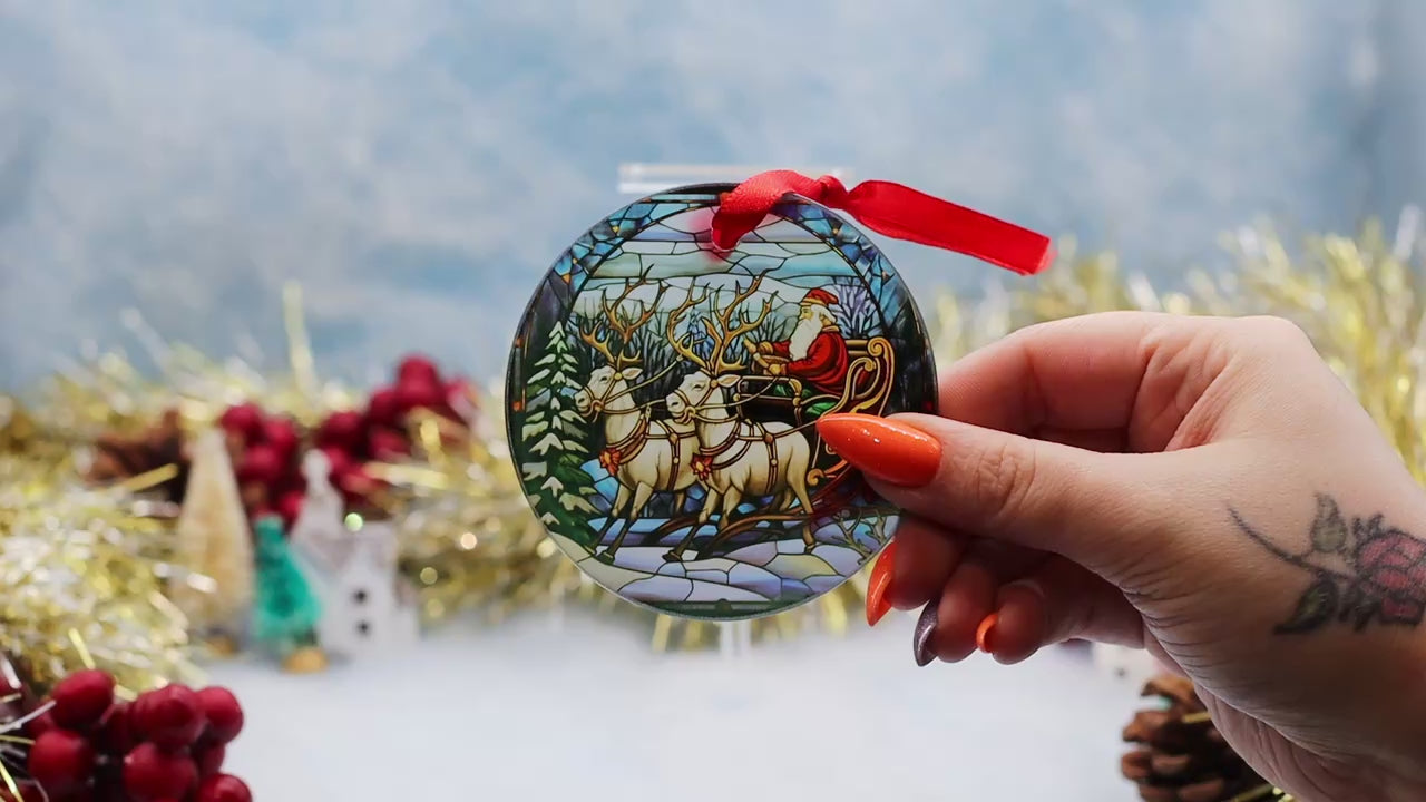 Video showcasing a frosted glass Christmas ornament showcasing a Santa sled scene