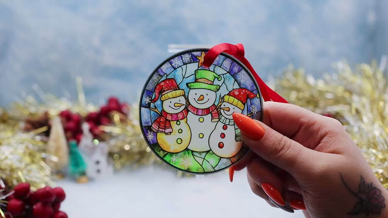 Video showcasing a frosted glass Christmas ornament featuring 2 snowman's on a stainless window image. 