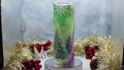 Video Showcasing A tall Stainless Steel Tumbler featuring a colourful printed Christmas tree design with pink, purple, and green ornaments, set on a silver pedestal with holiday decorations in the background.