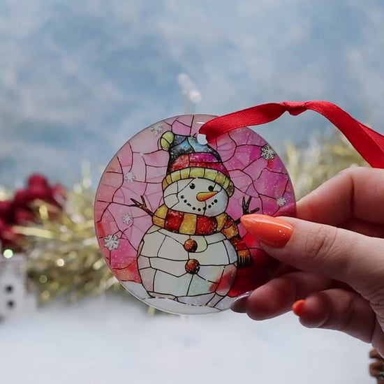 Video showcasing a frosted glass Christmas ornament featuring a snowman on a stain glassed effect image