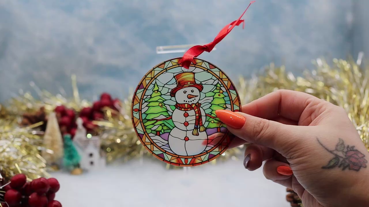 Video showcasing a frosted glass Christmas ornament featuring a stain glass theme illustration with a jolly snowman