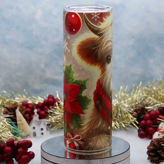 Video showcase A tall cylindrical tumbler with a clear lid, featuring a printed illustration of a fluffy Highland cow wearing a red plaid scarf, 