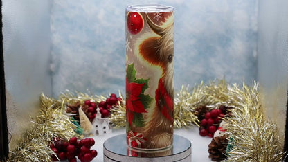 Video showcase A tall cylindrical tumbler with a clear lid, featuring a printed illustration of a fluffy Highland cow wearing a red plaid scarf, 
