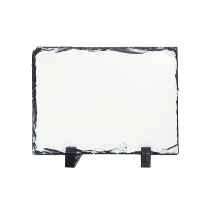 A rectangular slate with a dark natural border, displayed on a black stand against a plain white background.